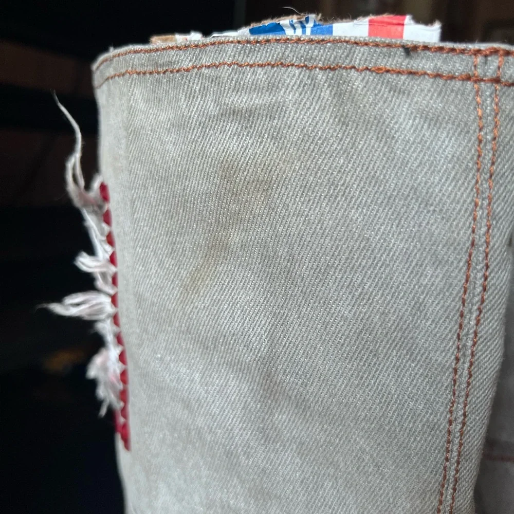 Woman’s multi-color red stone denim pointy toe knee-high boots.